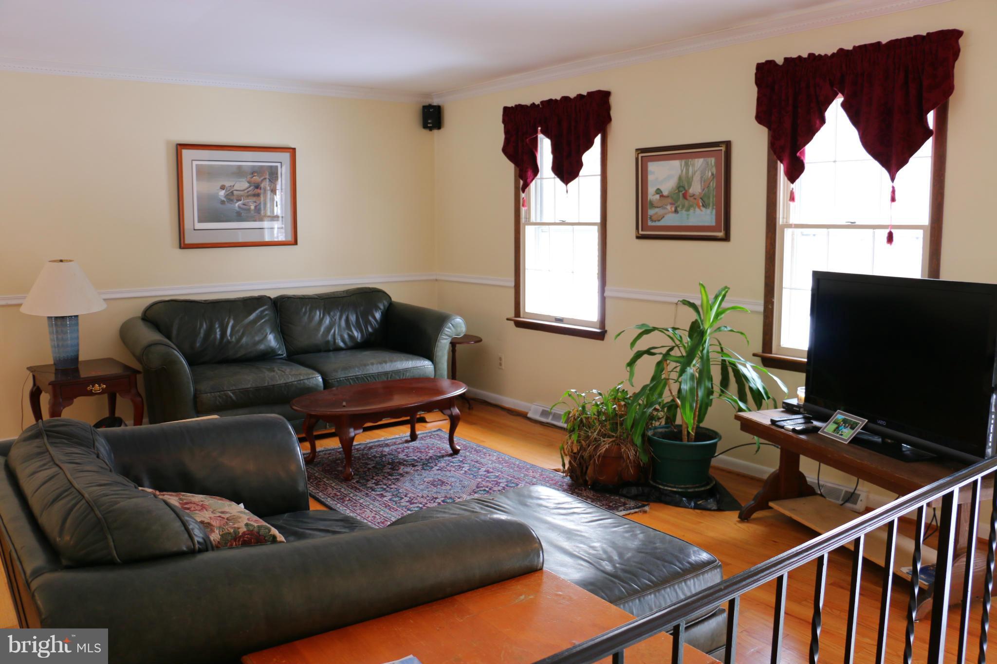 13831 Manor Road Baldwin, MD 21013 - Photo 8 of 20 a living room with furniture fireplace and window