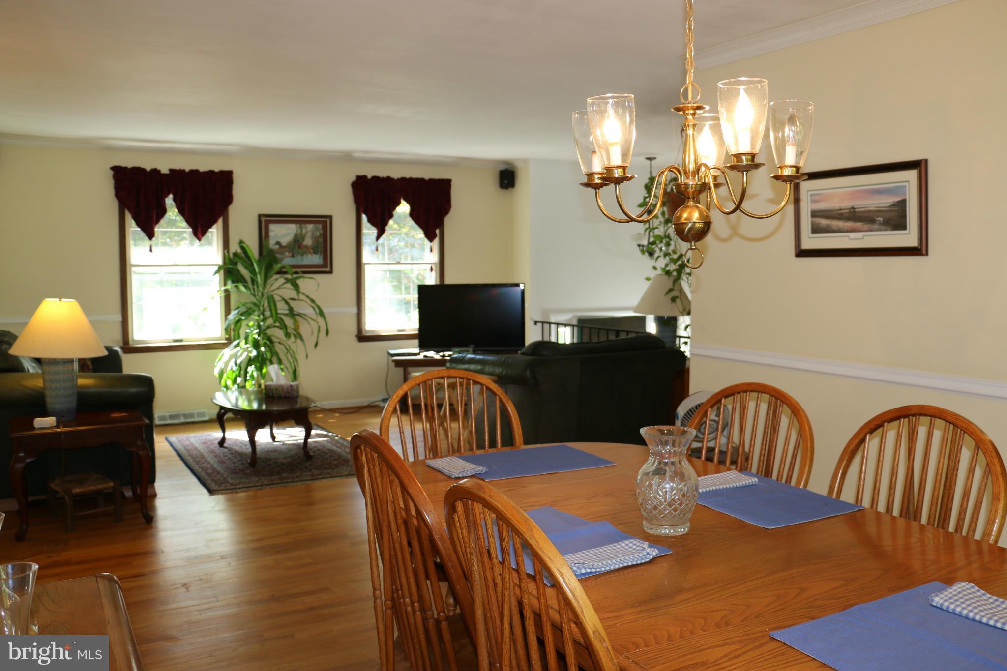 13831 Manor Road Baldwin, MD 21013 - Photo 10 of 20 a view of a dining room with furniture and wooden floor