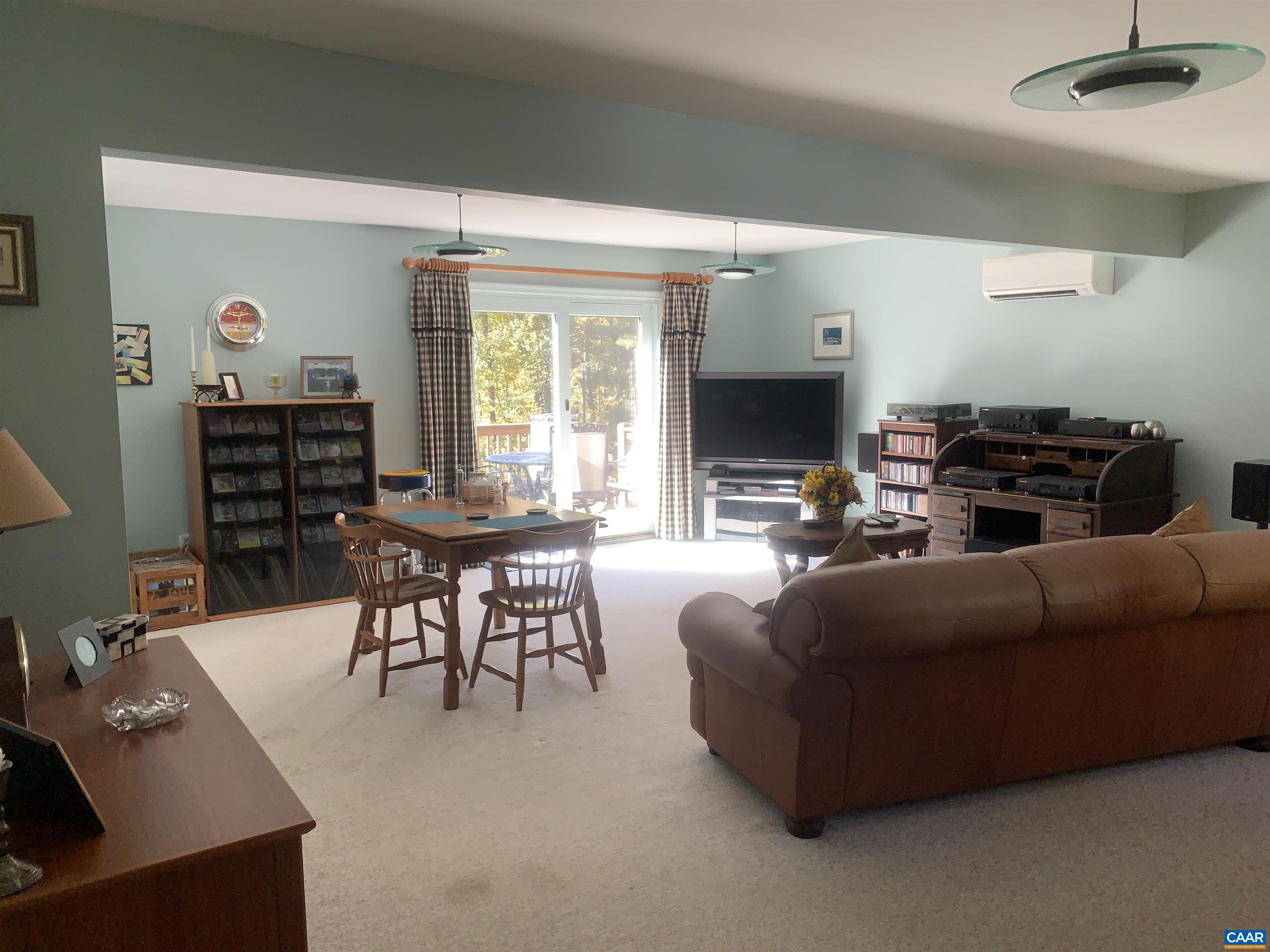 3034 Thrift Road Madison, VA 22727 - Photo 16 of 26 a living room with furniture a fireplace and a flat screen tv
