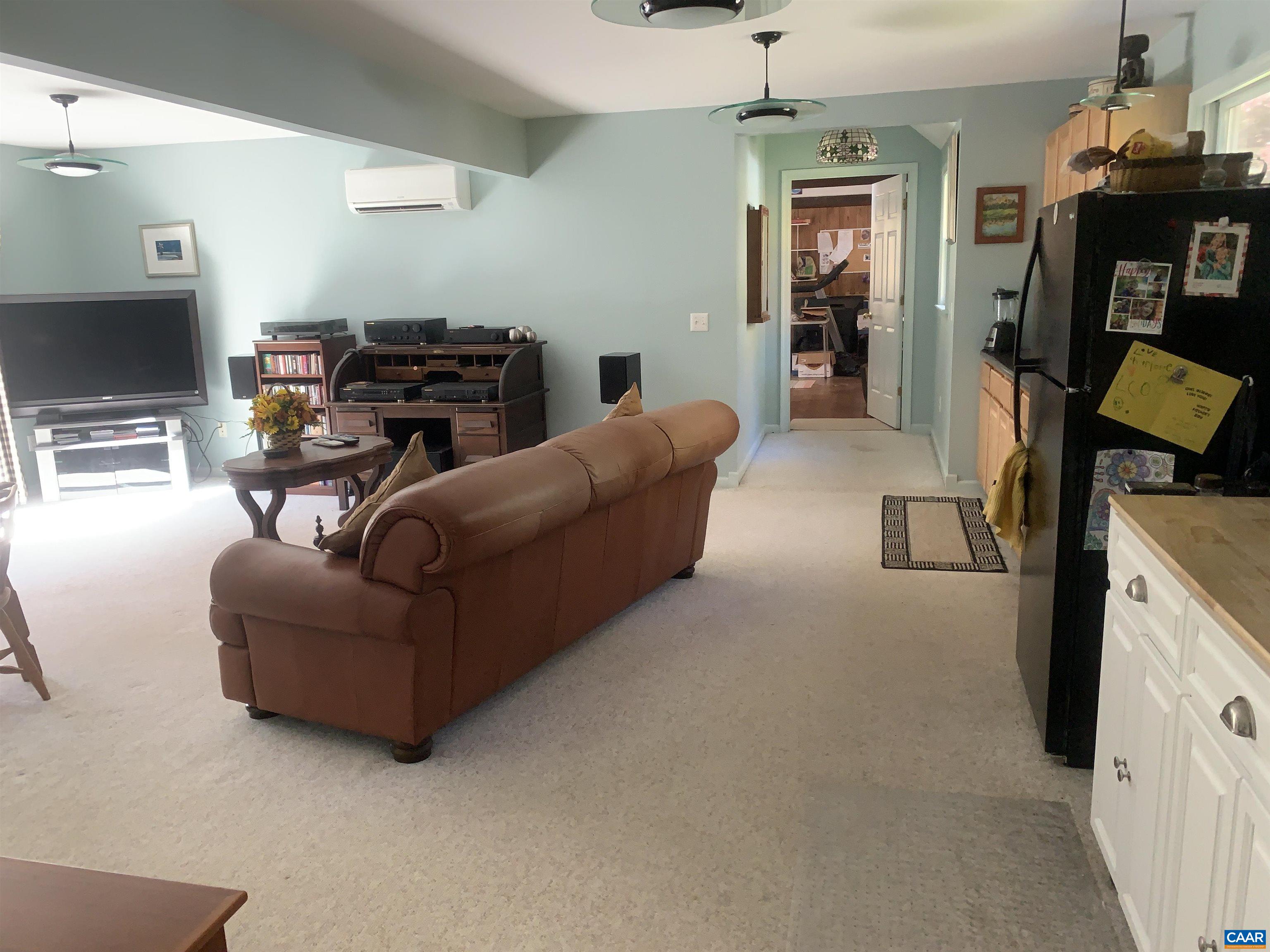 3034 Thrift Road Madison, VA 22727 - Photo 17 of 26 a living room with furniture a flat screen tv and a fireplace