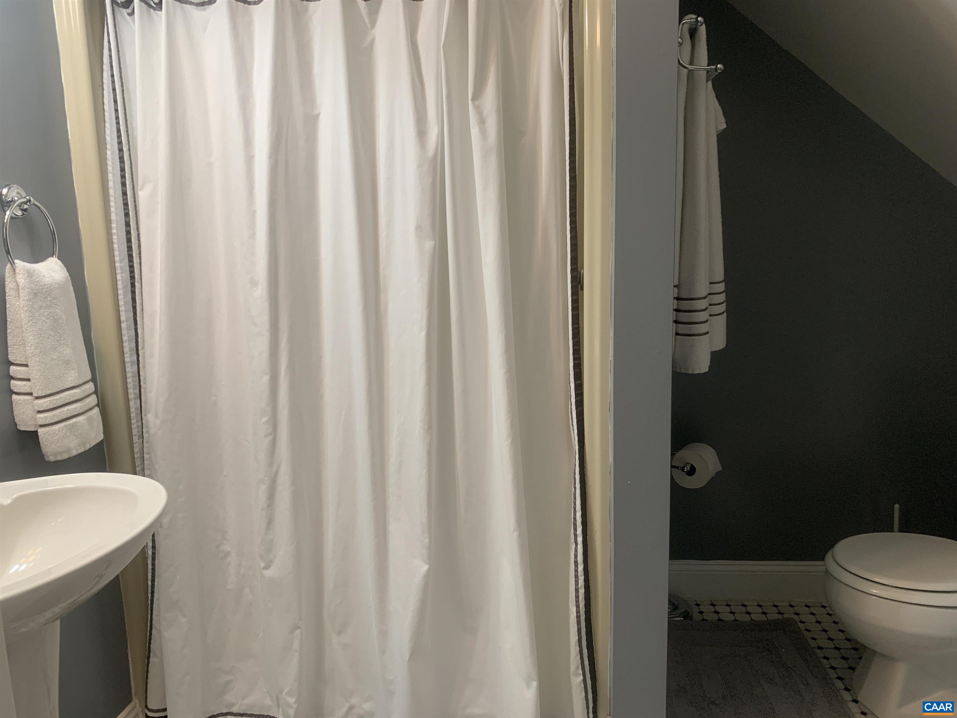 3034 Thrift Road Madison, VA 22727 - Photo 20 of 26 a bathroom with a granite countertop sink and a toilet