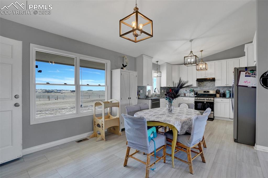 3805 Curtis Road Peyton, CO 80831 - Photo 17 of 48 a view of a dining room with furniture window and outside view