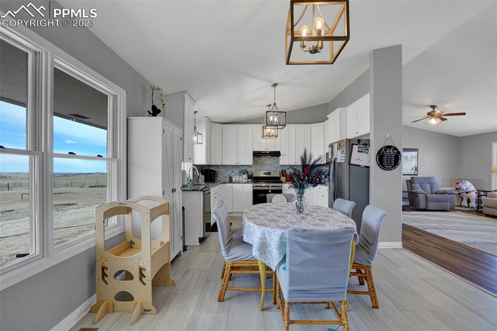 3805 Curtis Road Peyton, CO 80831 - Photo 18 of 48 a dining room with furniture a rug and wooden floor