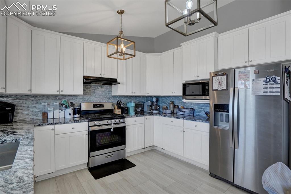 3805 Curtis Road Peyton, CO 80831 - Photo 20 of 48 a kitchen with stainless steel appliances a stove a sink and cabinets