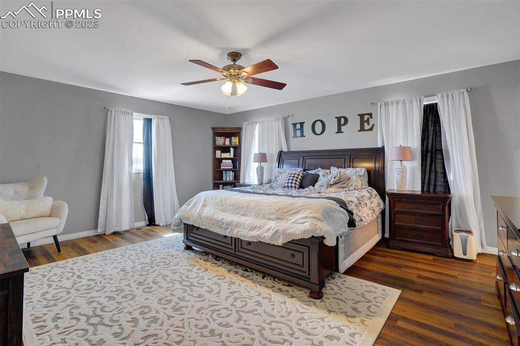 3805 Curtis Road Peyton, CO 80831 - Photo 23 of 48 a bed sitting in a spacious bedroom next to a window