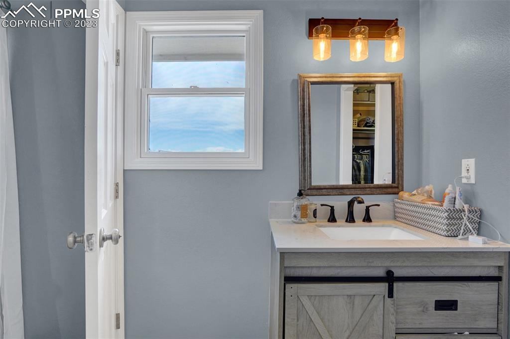 3805 Curtis Road Peyton, CO 80831 - Photo 27 of 48 a bathroom with a sink and a mirror