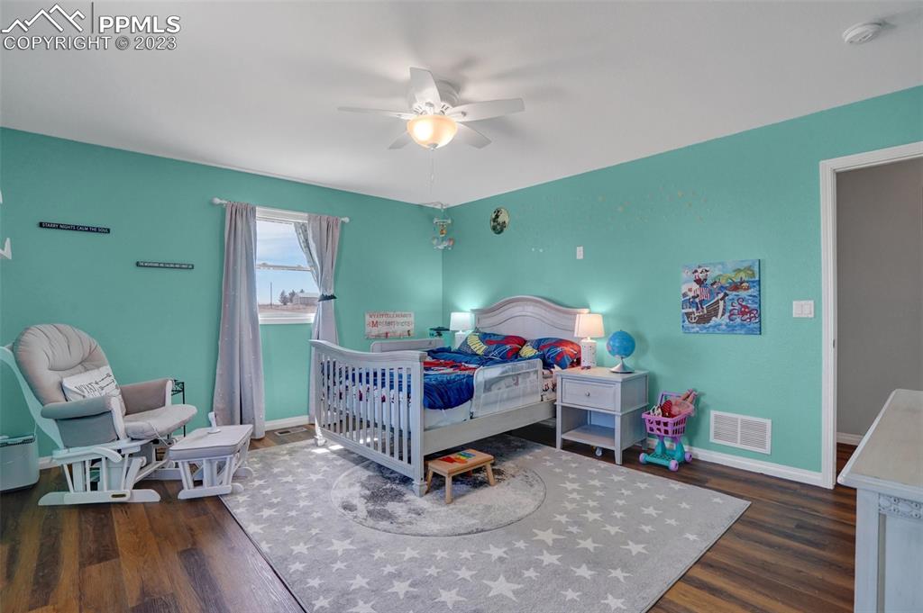 3805 Curtis Road Peyton, CO 80831 - Photo 29 of 48 a living room with furniture and a wooden floor