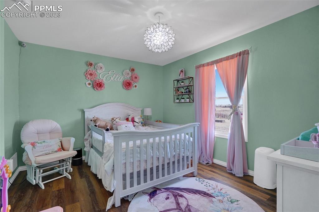 3805 Curtis Road Peyton, CO 80831 - Photo 31 of 48 a bedroom with a bed and a window