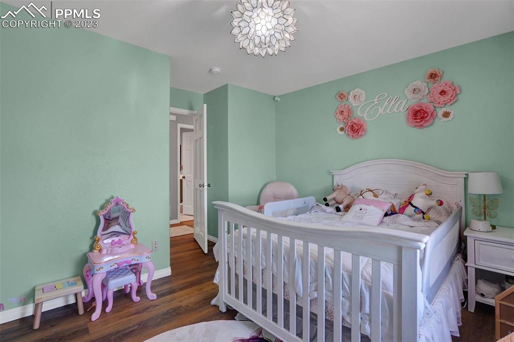 3805 Curtis Road Peyton, CO 80831 - Photo 32 of 48 a bedroom with furniture and wooden floor