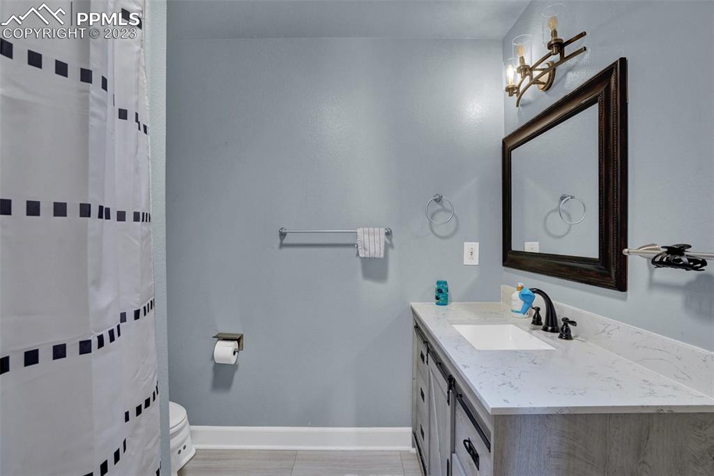 3805 Curtis Road Peyton, CO 80831 - Photo 33 of 48 a bathroom with a tub sink and mirror