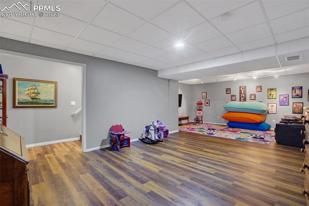 3805 Curtis Road Peyton, CO 80831 - Photo 35 of 48 a room with wooden floor and furniture