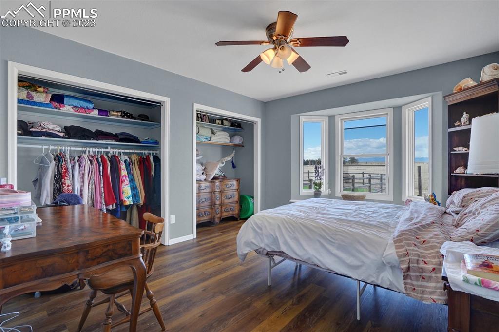 3805 Curtis Road Peyton, CO 80831 - Photo 42 of 48 a bedroom with a bed and a chandelier