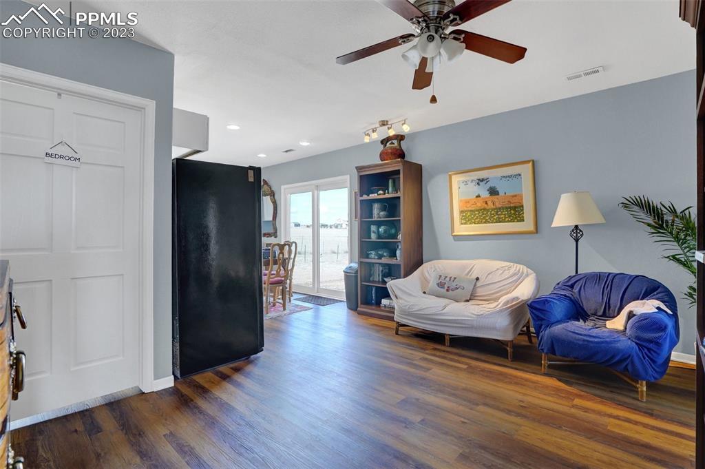 3805 Curtis Road Peyton, CO 80831 - Photo 45 of 48 a living room with furniture ceiling fan and a rug