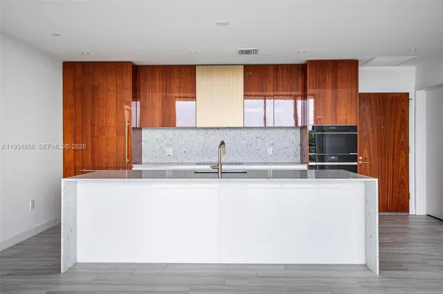 a kitchen with stainless steel appliances granite countertop a sink a stove and a microwave oven