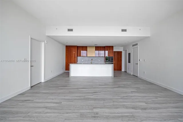 a view of a kitchen with a sink and a refrigerator