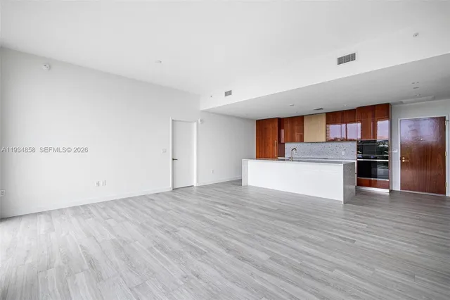 a view of a kitchen with a sink and a refrigerator