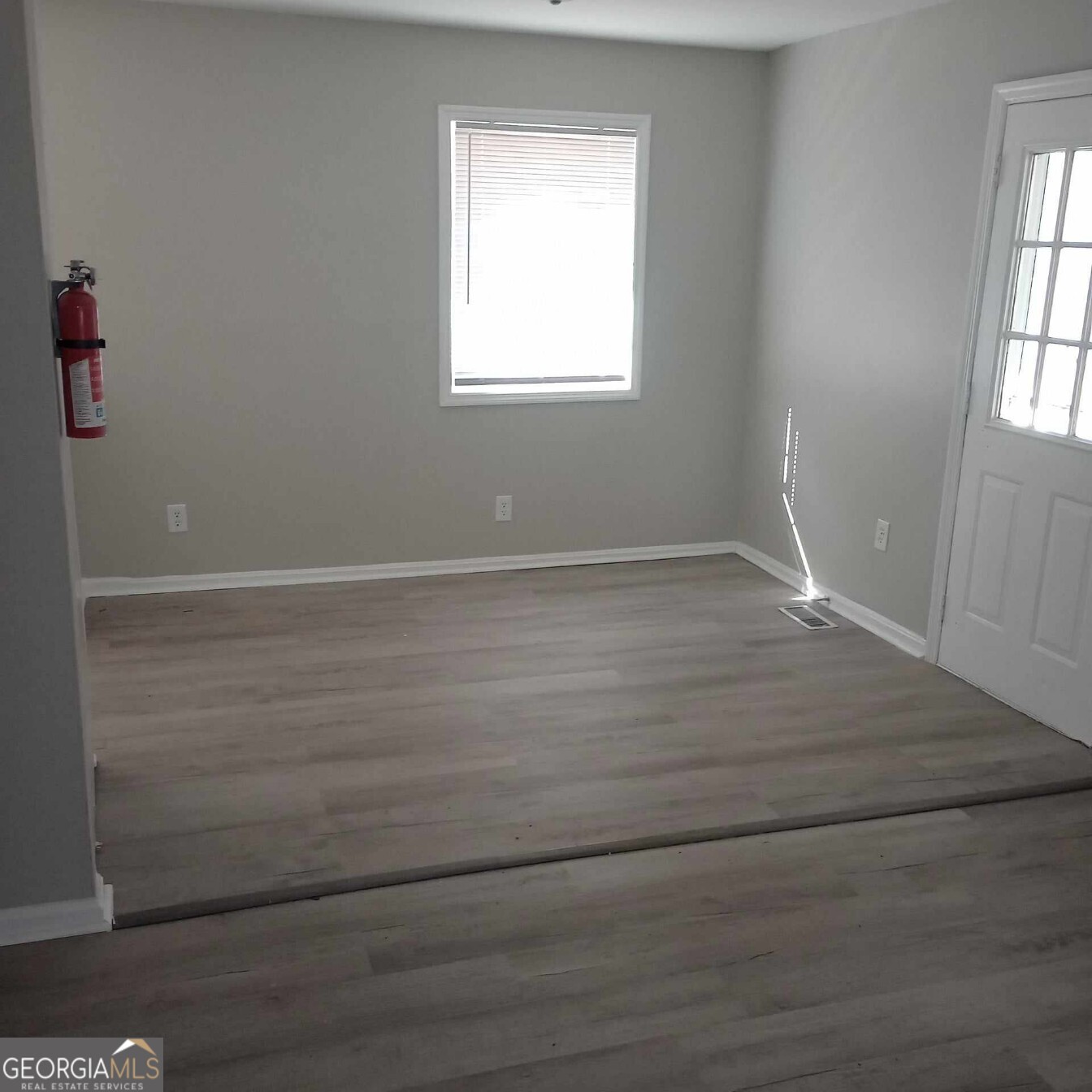 193 Frazier Drive Southeast Milledgeville, GA 31061 - Photo 27 of 38 an empty room with wooden floor and windows