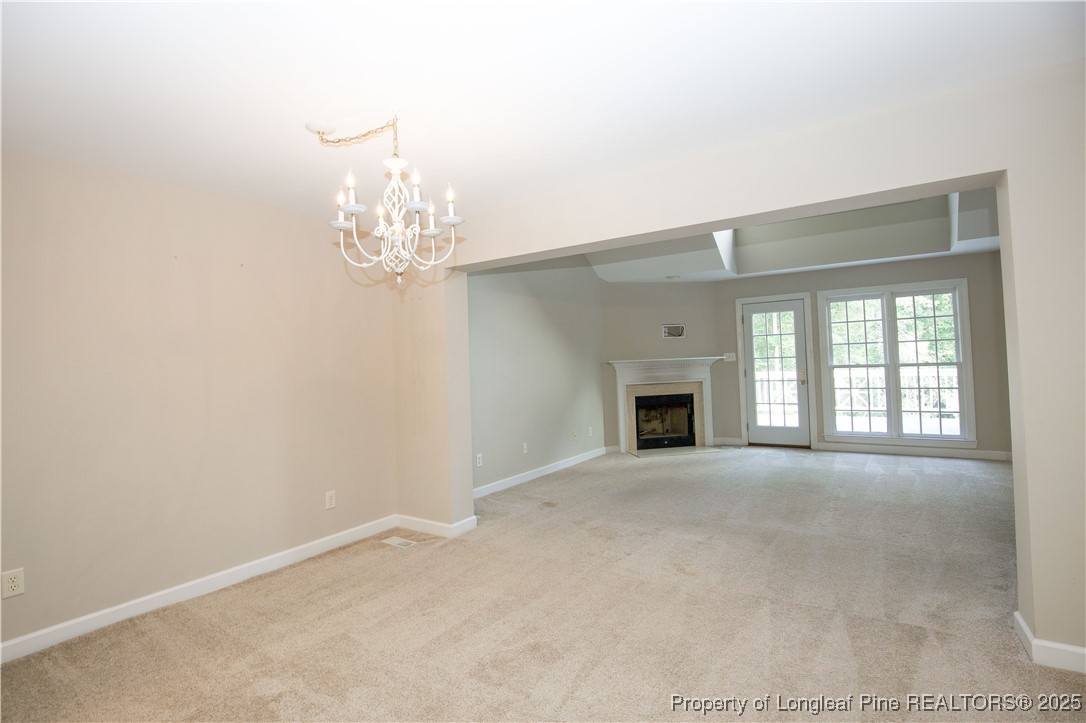 175 Knoll Road Southern Pines, NC 28387 - Photo 13 of 50 en empty room with windows and fireplace