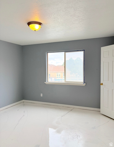 8116 North Ridge Loop West, Unit 8 Eagle Mountain, UT 84005 - Photo 10 of 23 Unfurnished room with baseboards and a textured ceiling