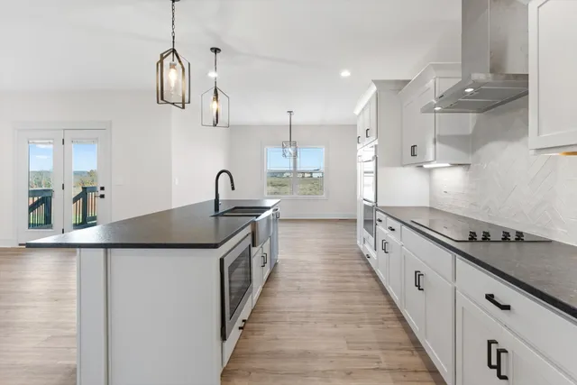 a kitchen with stainless steel appliances granite countertop a sink and cabinets