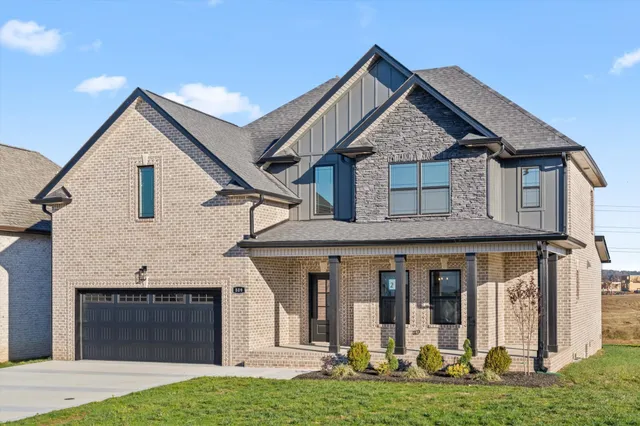 a front view of a house with a yard and garage