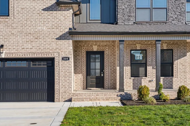 a front view of a house with outdoor seating