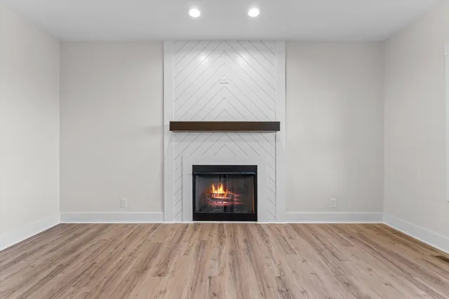 a room with a fireplace and wooden floor