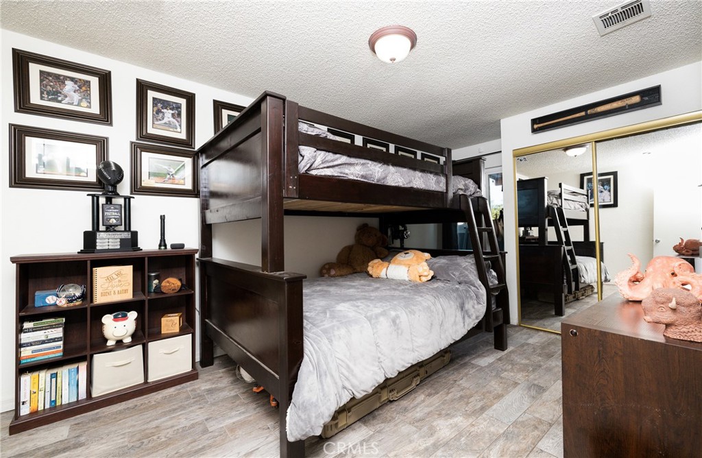 6667 King Street Chino, CA 91710 - Photo 12 of 21 a bed room with a bed and a walk in closet