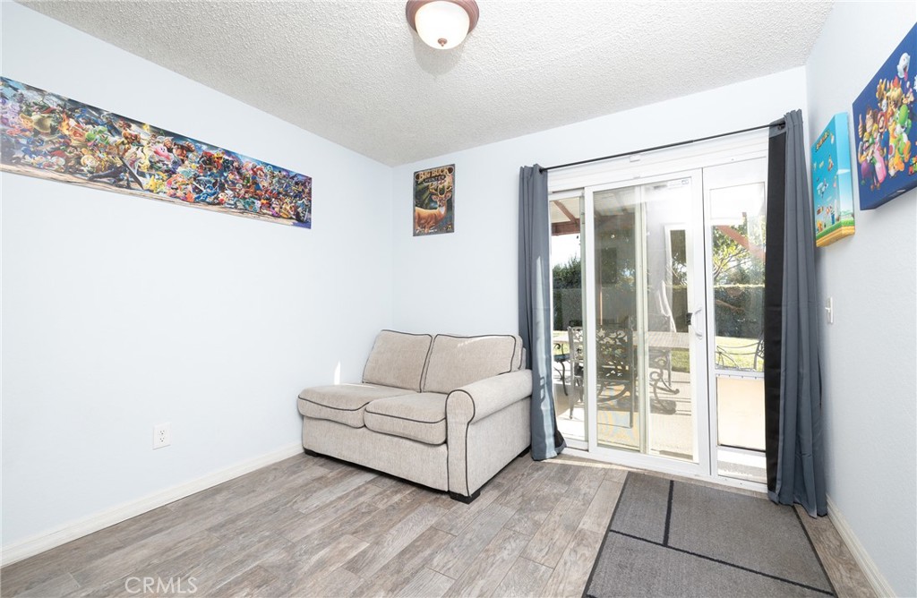 6667 King Street Chino, CA 91710 - Photo 16 of 21 a living room with furniture and a floor to ceiling window