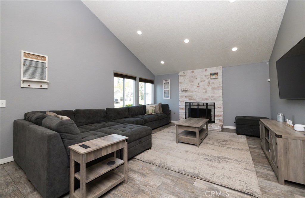 6667 King Street Chino, CA 91710 - Photo 4 of 21 a living room with furniture a flat screen tv and a fireplace
