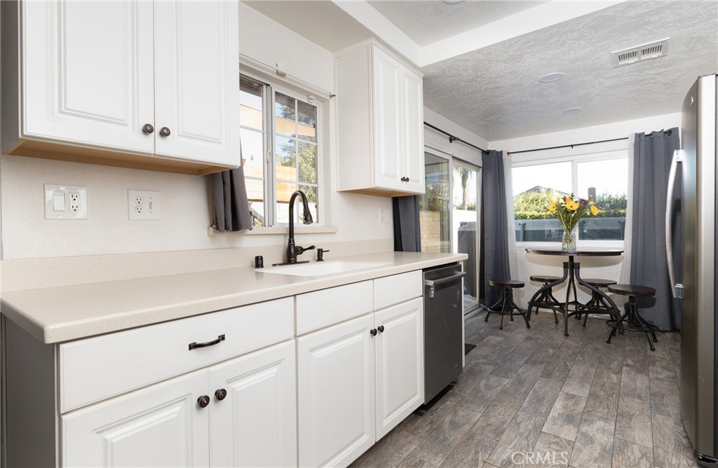6667 King Street Chino, CA 91710 - Photo 9 of 21 a kitchen with sink cabinets and dining table