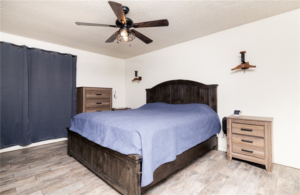 6667 King Street Chino, CA 91710 - Photo 10 of 21 a bedroom with a bed and a chandelier