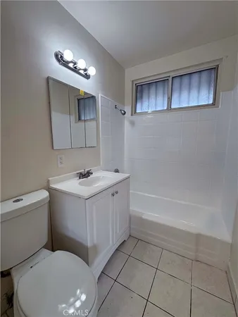 a bathroom with a sink a toilet and bathtub