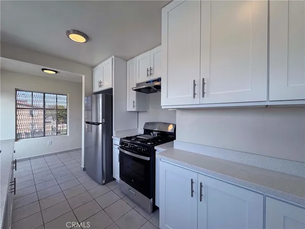 a kitchen with stainless steel appliances granite countertop a stove and a refrigerator