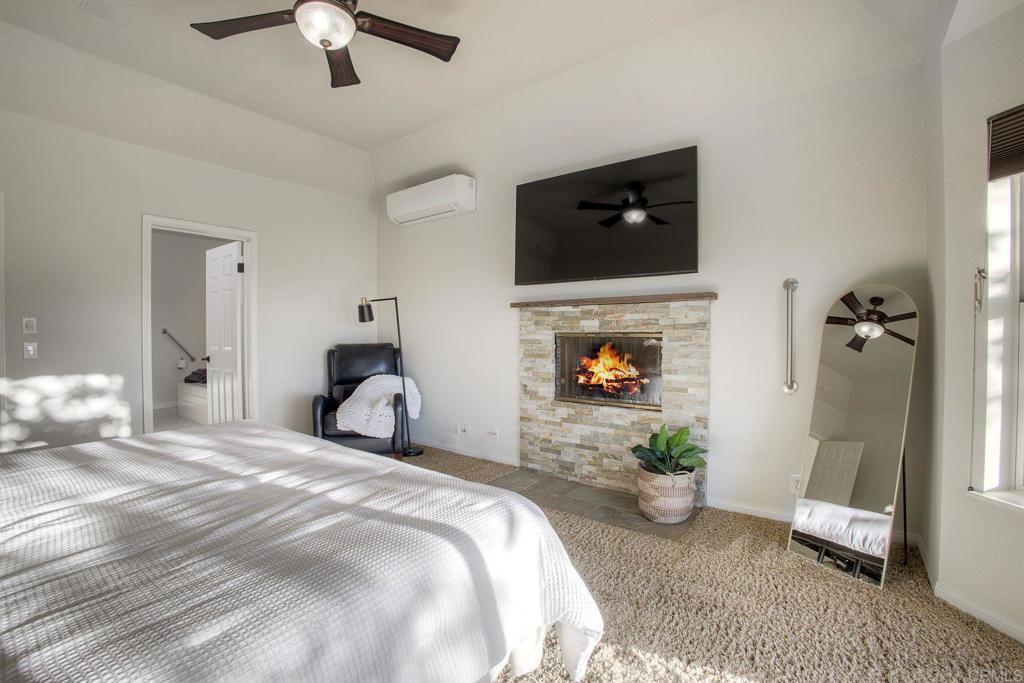 31220 Aquaduct Road Bonsall, CA 92003 - Photo 17 of 36 a bedroom with a bed and a chandelier