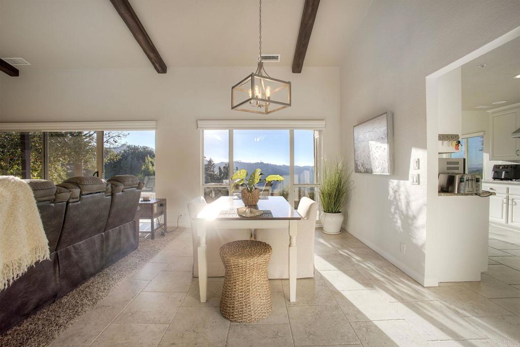 31220 Aquaduct Road Bonsall, CA 92003 - Photo 6 of 36 a view of a dining room with furniture wooden floor and a chandelier