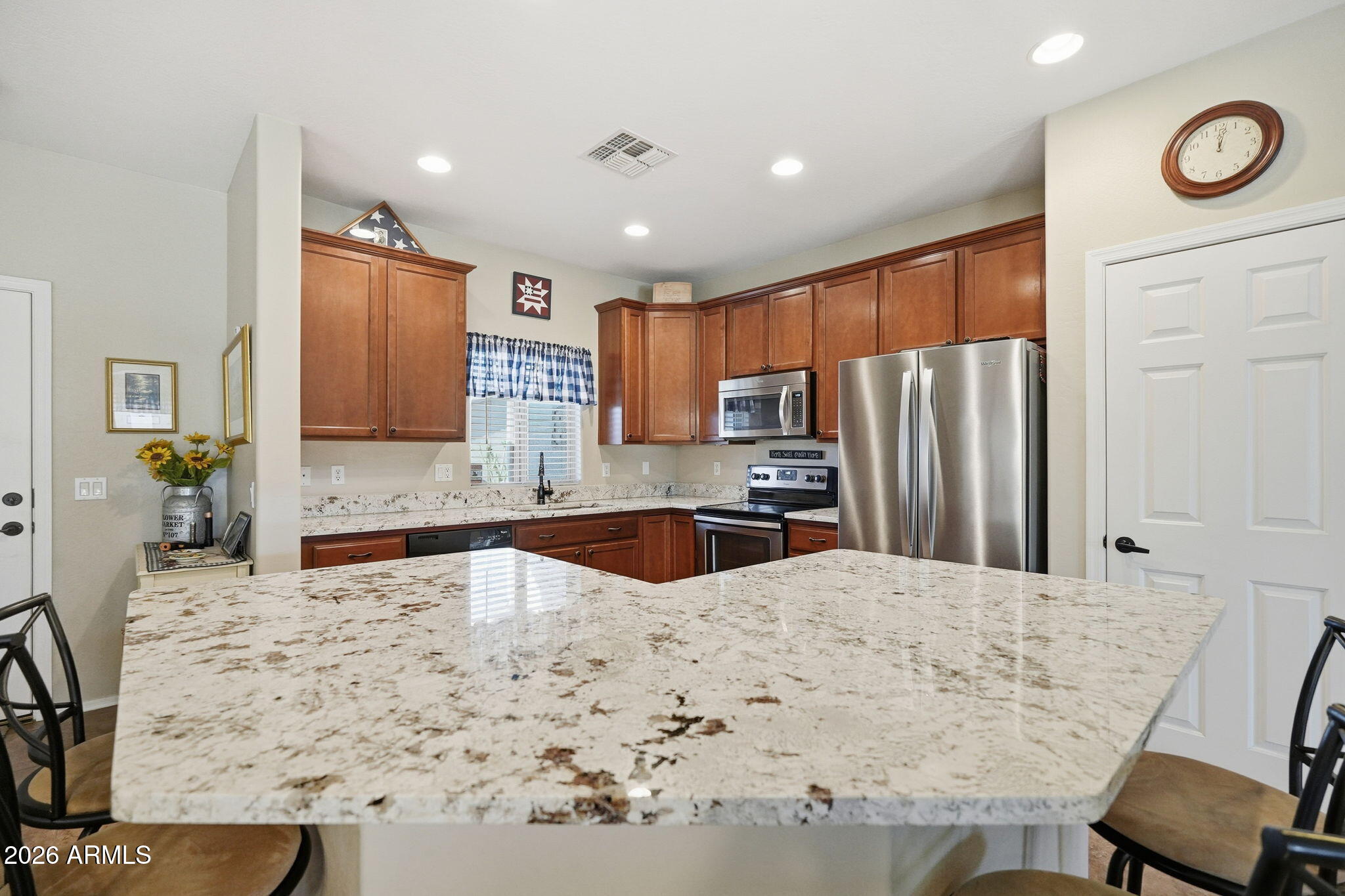 2101 South Meridian Road, Unit 164 Apache Junction, AZ 85120 - Photo 2 of 29 a kitchen with stainless steel appliances kitchen island granite countertop a refrigerator and microwave
