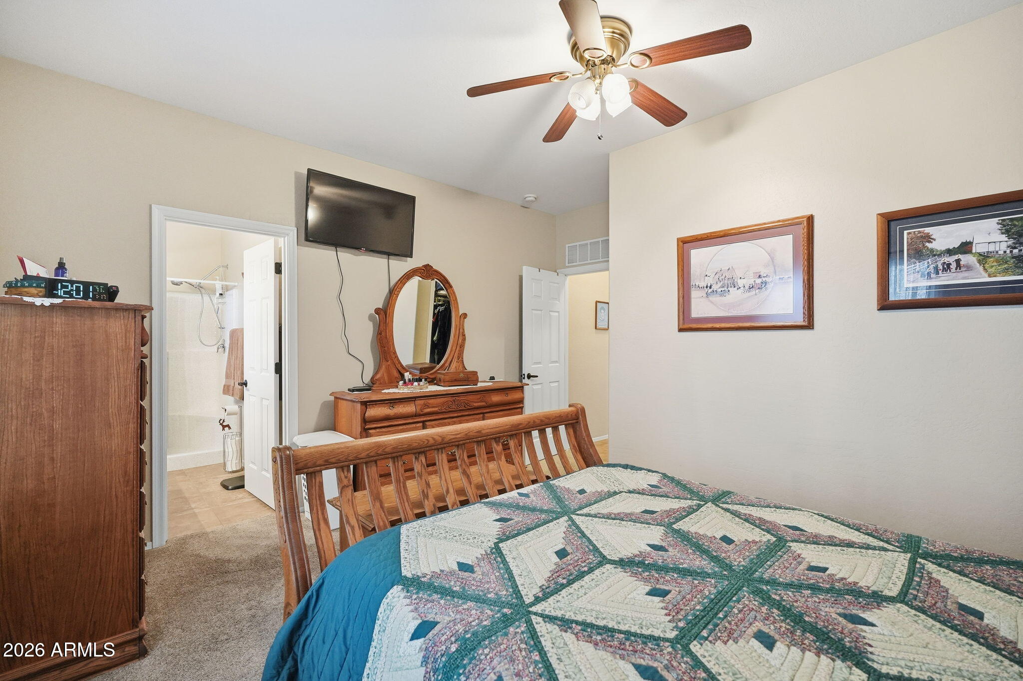 2101 South Meridian Road, Unit 164 Apache Junction, AZ 85120 - Photo 10 of 29 a bedroom with a bed and a chandelier