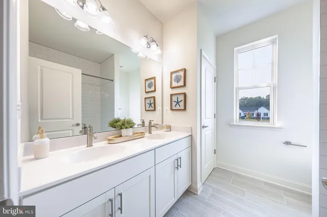 a bathroom with a double vanity sink and a mirror