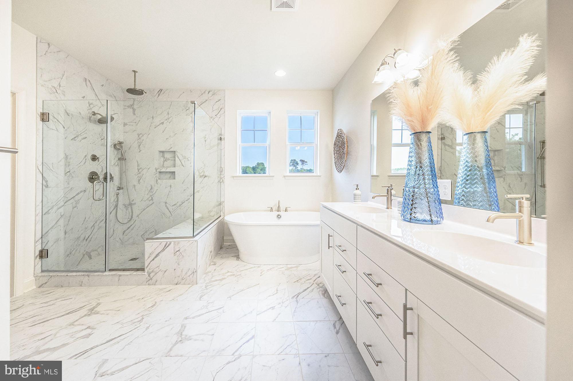 850 Brookfield Drive Dover, DE 19901 - Photo 8 of 11 a spacious bathroom with a double vanity sink toilet mirror and bathtub