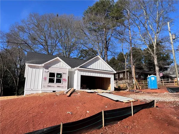 a view of house with yard outdoor seating and covered with snow in front of house