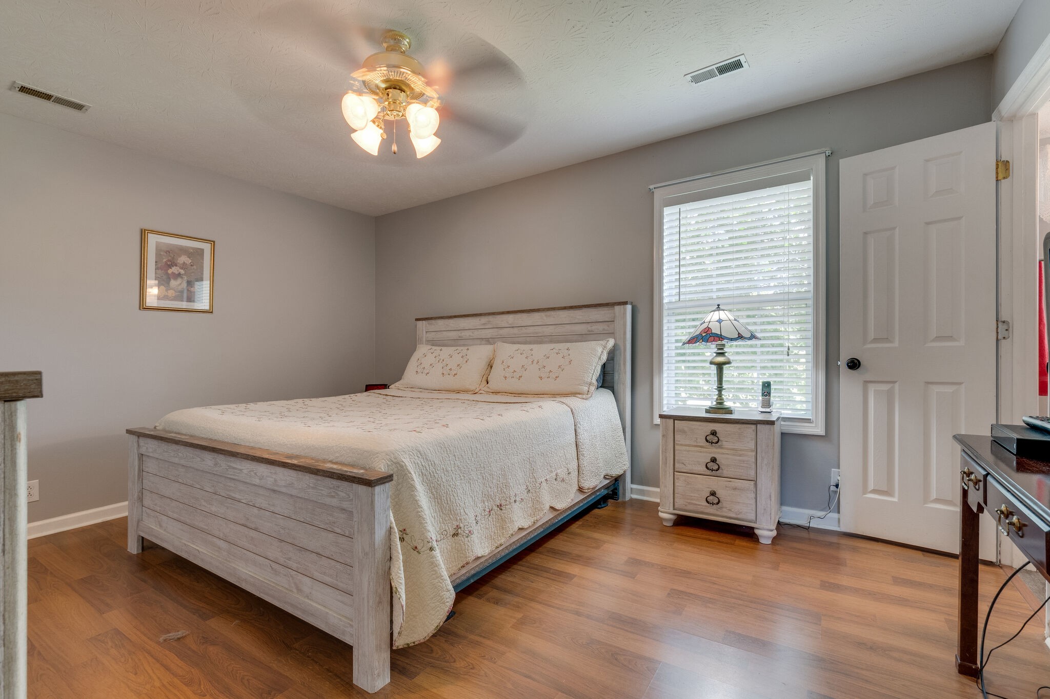 2143 Lee Road Spring Hill, TN 37174 - Photo 15 of 25 a bedroom with a bed and a chandelier
