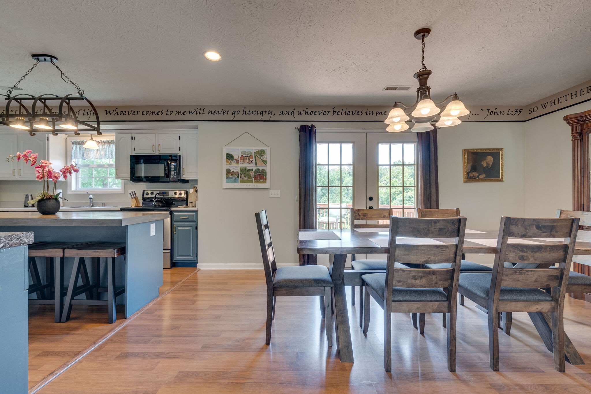 2143 Lee Road Spring Hill, TN 37174 - Photo 10 of 25 a kitchen with stainless steel appliances granite countertop a stove top oven a sink dishwasher a dining table and chairs with wooden floor