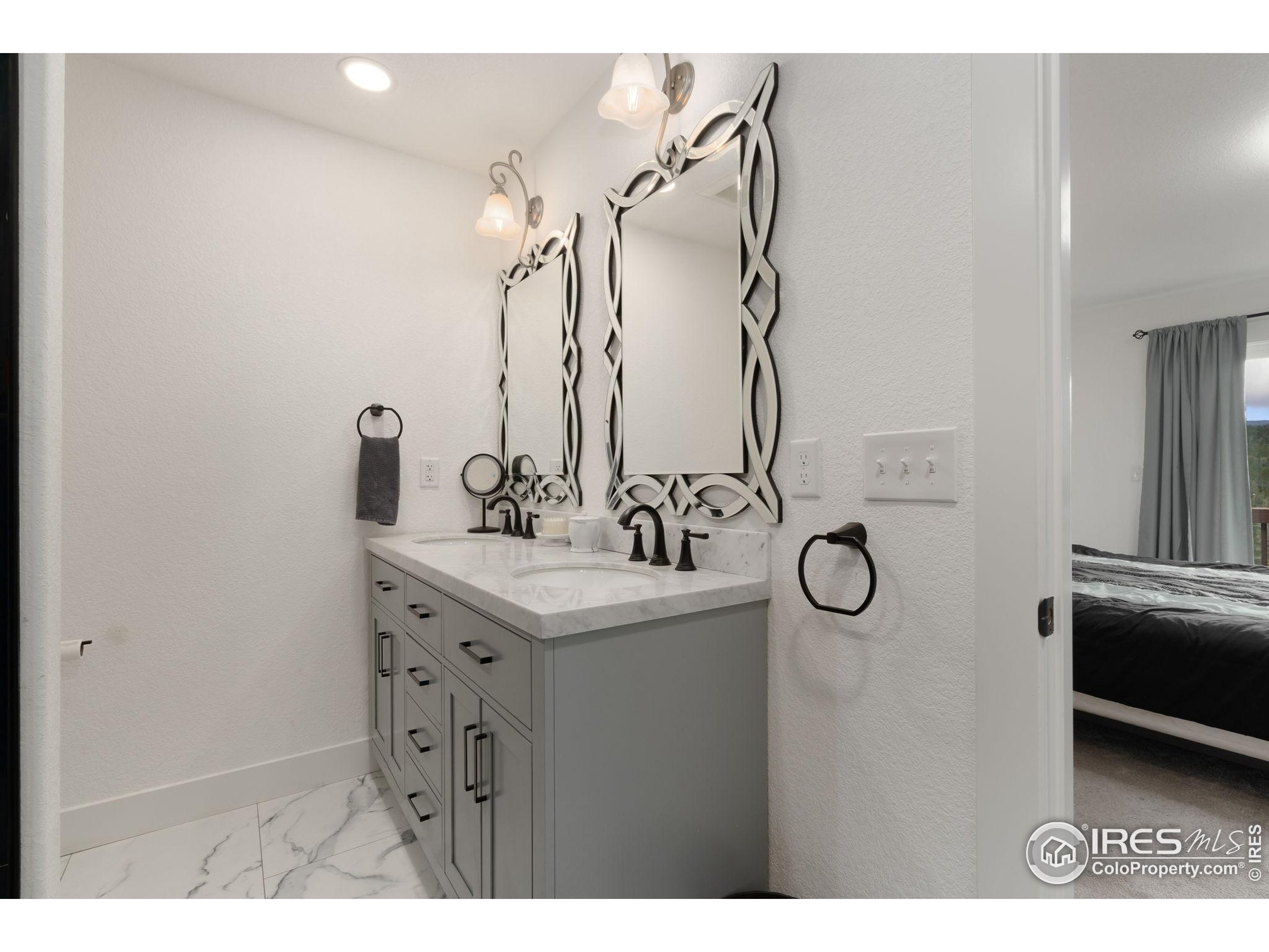 141 Tami Road Red Feather Lakes, CO 80545 - Photo 17 of 49 a bathroom with a sink and a mirror