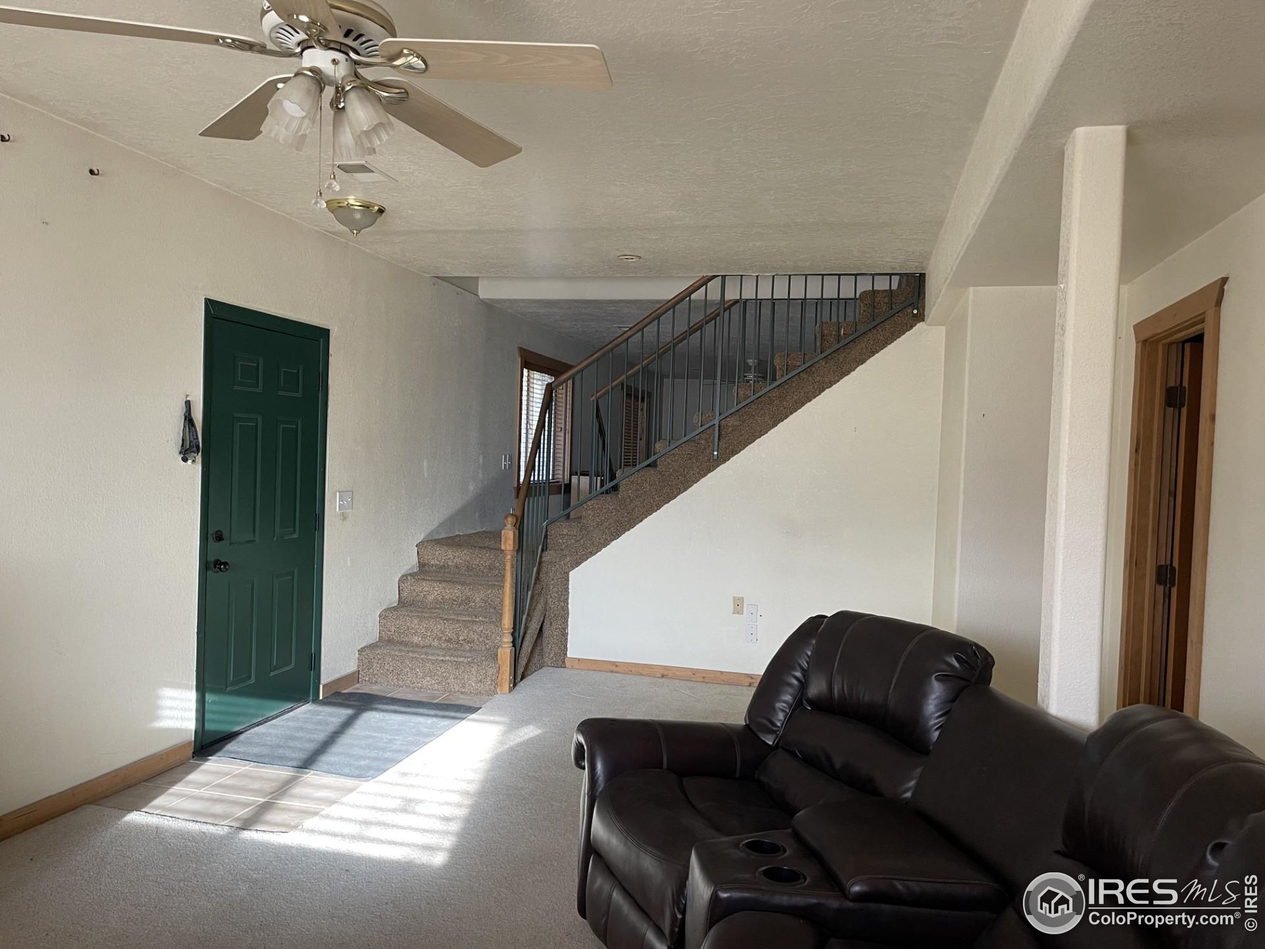 141 Tami Road Red Feather Lakes, CO 80545 - Photo 28 of 49 a living room with furniture and a chandelier
