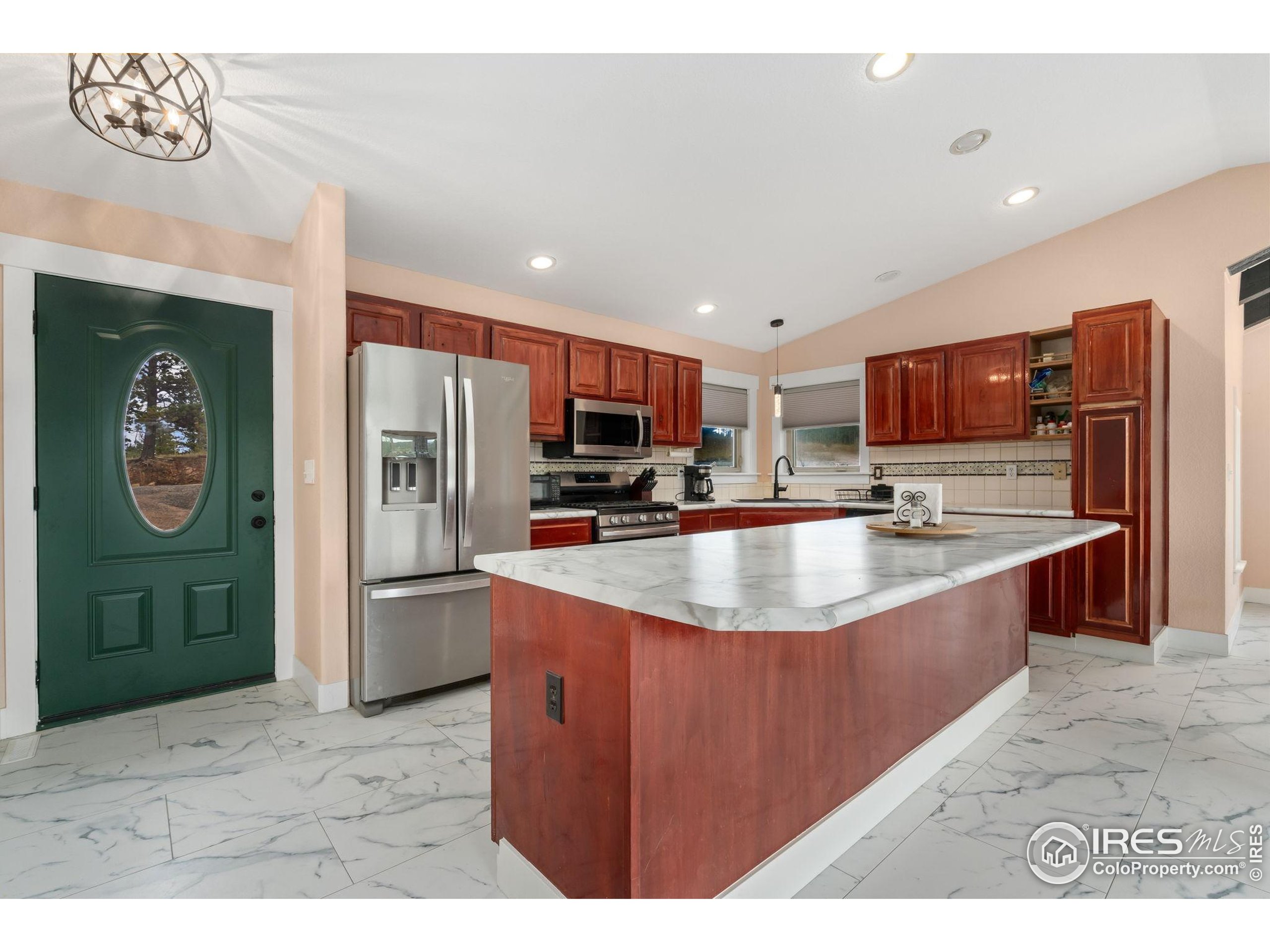 141 Tami Road Red Feather Lakes, CO 80545 - Photo 6 of 49 a kitchen with stainless steel appliances granite countertop a refrigerator and a sink