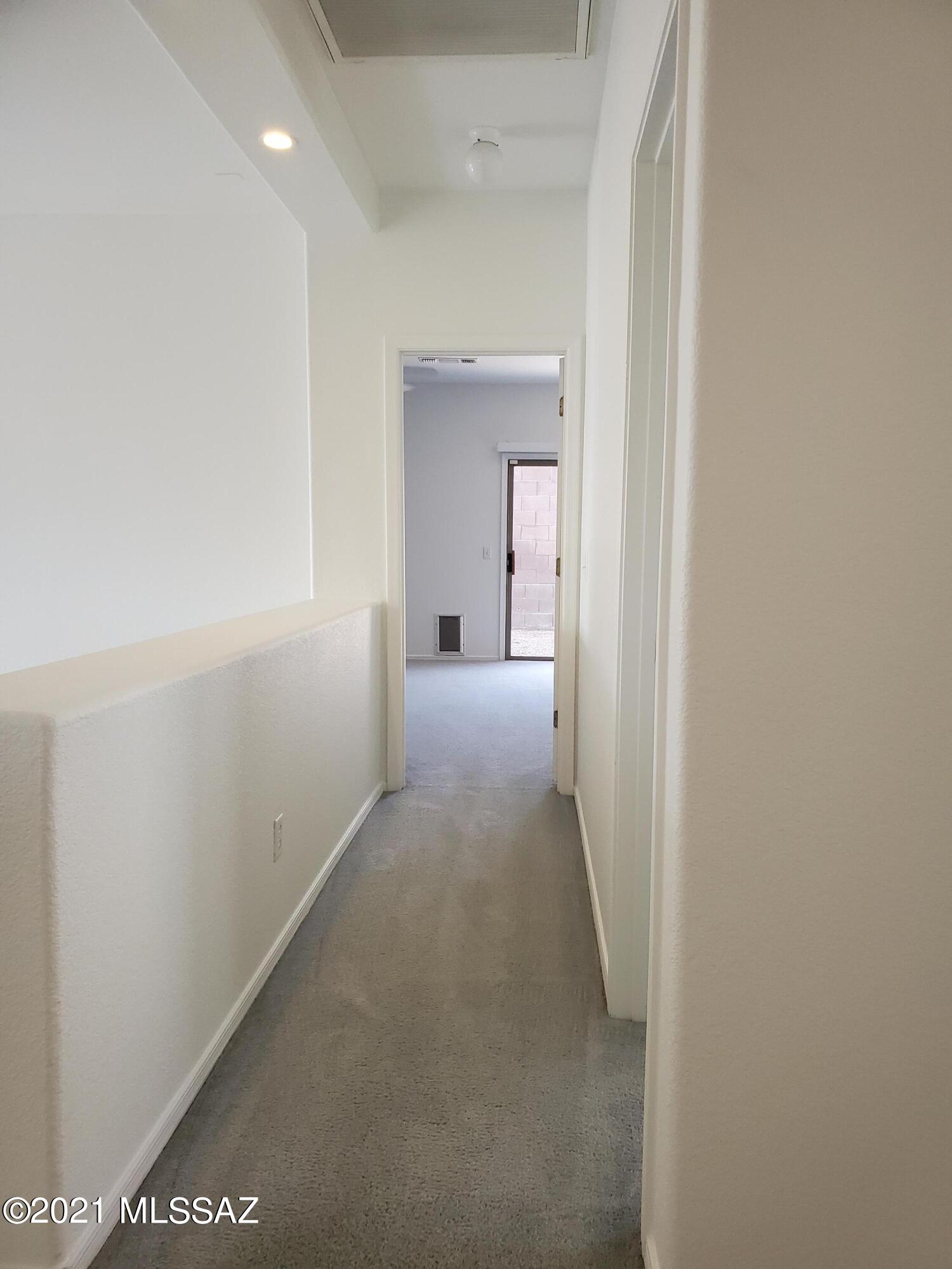 3455 North Boyce Spring Lane Tucson, AZ 85745 - Photo 8 of 21 a view of a hallway with wooden floor and a bathroom