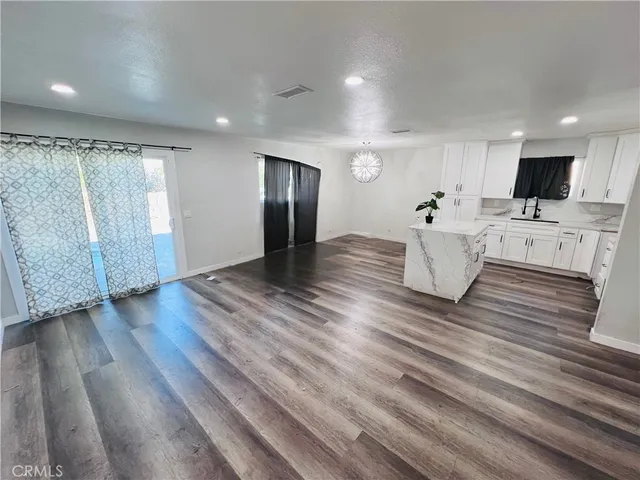 a view of kitchen with cabinets and wooden floor