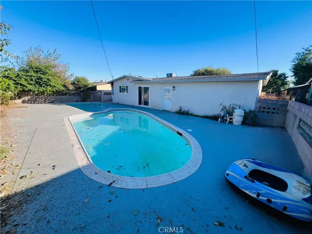 an aerial view of a house with pool table and chairs