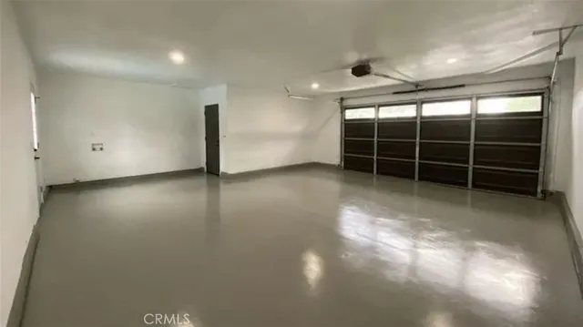 a view of an empty room with a fireplace and lots of wooden furniture